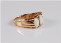 Lot 2594 - A 9ct opal and diamond ring, the three oval...