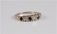 Lot 2656 - An 18ct sapphire and diamond half hoop ring,...