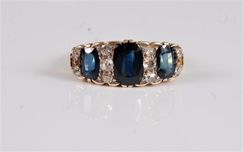 Lot 2593 - An 18ct sapphire and diamond ring, the central...