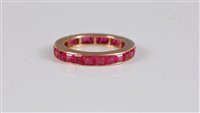 Lot 2579 - A synthetic pink sapphire eternity ring, the...