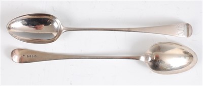 Lot 1165 - A pair of George III silver stuffing spoons,...