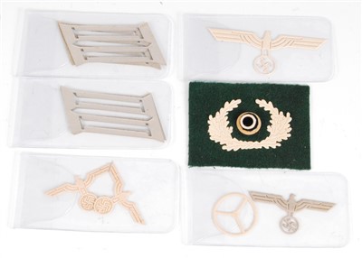 Lot 104 - A collection of German eagle collar tab templates, together with a cloth badge etc.