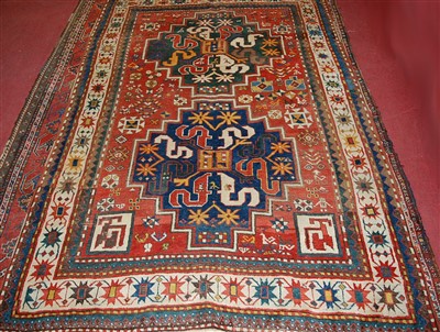 Lot 1556 - A circa 1900 Persian woollen rug, the red...