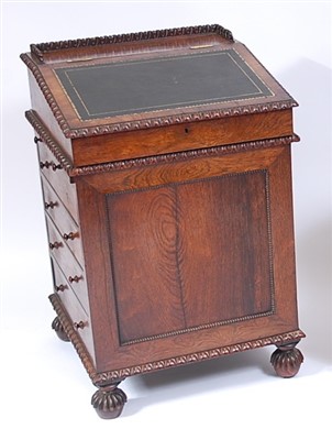 Lot 1568 - A 19th century rosewood slide-top Davenport,...