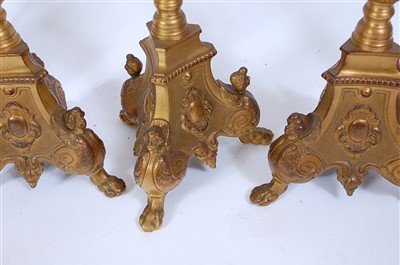 Lot 1384 - A set of four gilt brass alter sticks, in the...