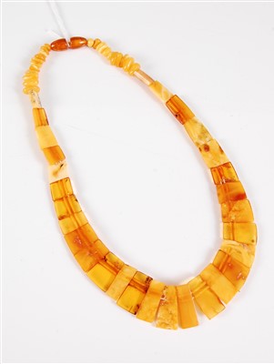 Lot 300 - An amber necklace, the graduated tapered flat...