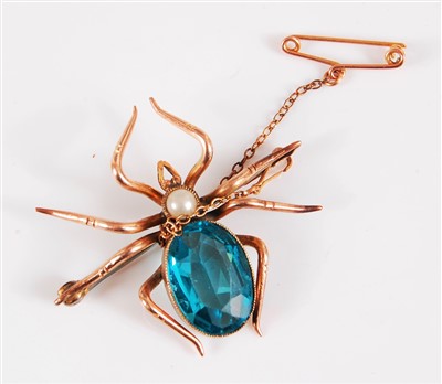 Lot 303 - A spider brooch, the oval blue paste body set...