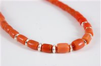 Lot 2570 - A coral bead necklace, the barrel shaped beads...