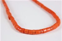 Lot 2572 - A coral bead necklace, the barrel shaped beads...