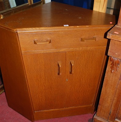 Lot 1103 - A 1970s G-Plan oak low double door corner...