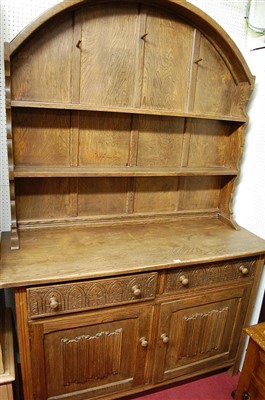 Lot 1119 - An oak dome topped dresser, having twin...