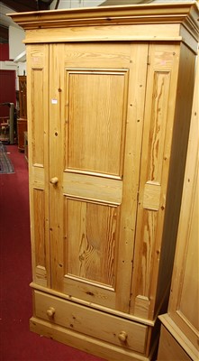 Lot 1121 - A modern pine single door wardrobe, having...