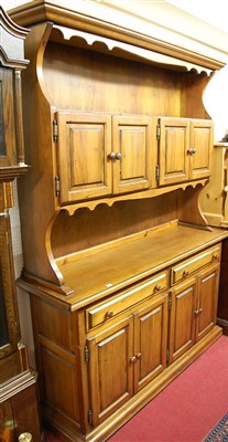 Lot 1128 - A modern stained pine dresser, having four...