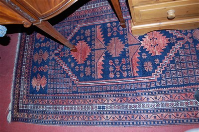 Lot 1163 - A Persian woollen blue ground rug, having a...