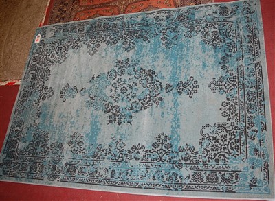 Lot 1168 - A Persian style machine woven blue ground rug,...