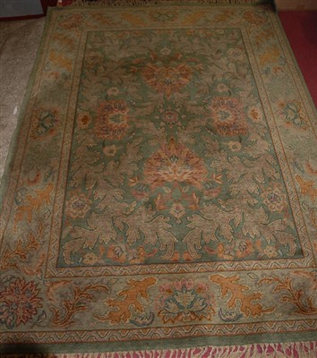 Lot 1170 - A Persian style machine woven green ground rug