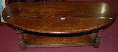 Lot 1244 - A joined oak drop flap coffee table, raised on...