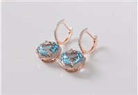 Lot 1219 - A pair of 14k topaz and diamond earrings, the...