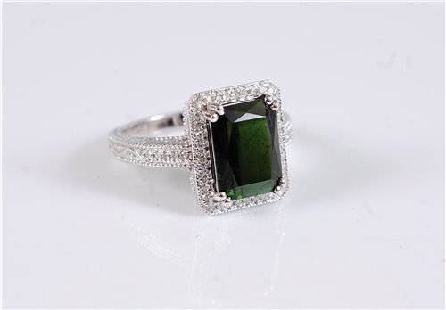 Lot 1292 - A 14k green tourmaline and diamond ring, the...