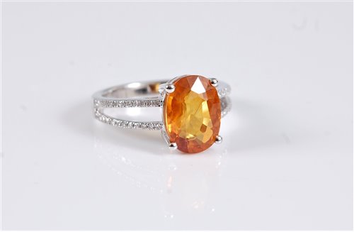 Lot 1296 - A 14k yellow sapphire and diamond ring, the...