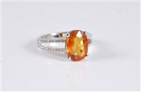 Lot 1296 - A 14k yellow sapphire and diamond ring, the...