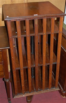 Lot 1255 - An Edwardian walnut revolving bookcase having...