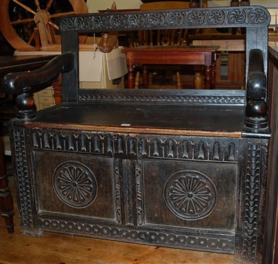 Lot 1308 - An antique joined and relief carved oak twin...