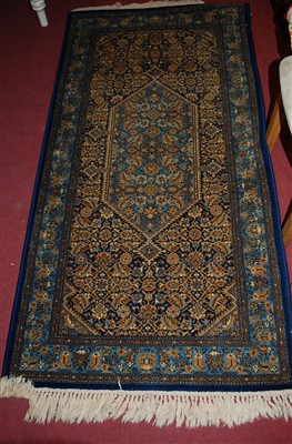 Lot 1324 - A Persian style red ground machine woven hall...