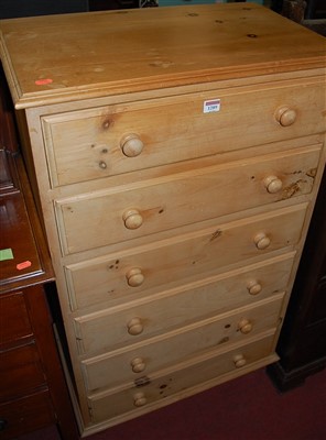 Lot 1289 - A modern pine narrow chest of six long drawers,...