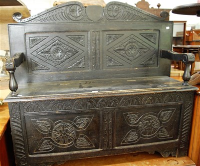 Lot 1412 - A circa 1900 ebonised and relief carved oak...