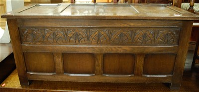 Lot 1415 - A contemporary panelled oak and relief carved...