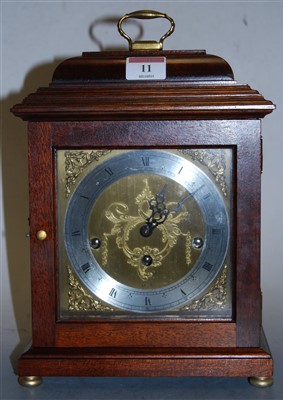 Lot 11 - A modern mahogany cased mantel clock, the...