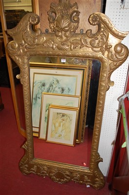 Lot 1097 - A gilt composition relief moulded wall mirror...