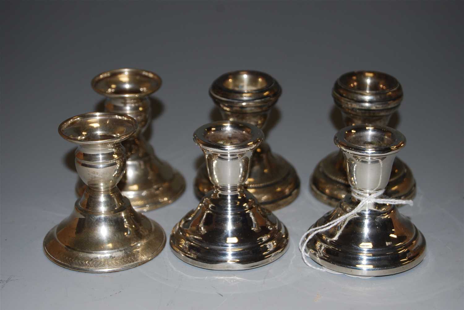 Lot 224 - Three pairs of silver dwarf candlesticks, each...