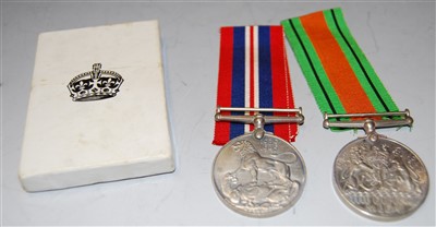 Lot 390 - A pair of WWII medals to include Defence & War...