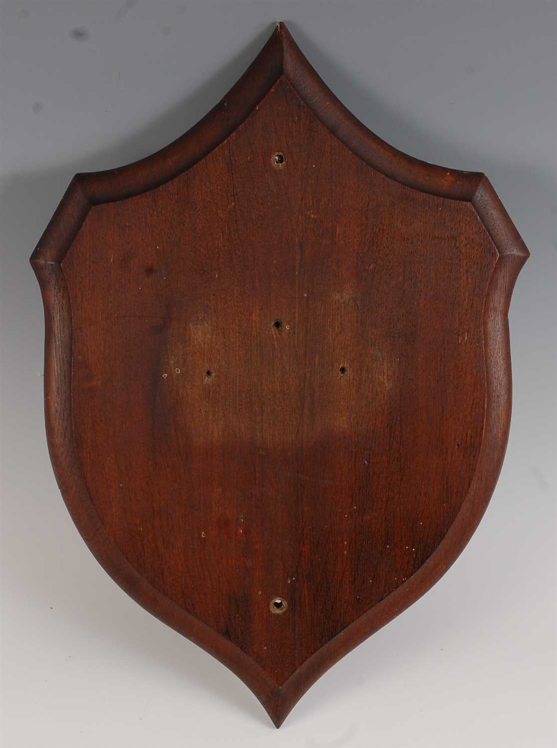 Lot 478 - An early 20th century oak shield shaped plinth