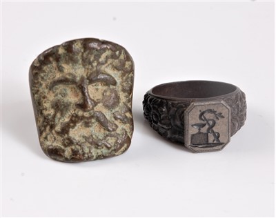 Lot 1291 - A bronze mask ring, possibly Roman, the face...