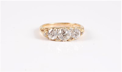 Lot 1309 - An 18ct three stone diamond ring, the three...