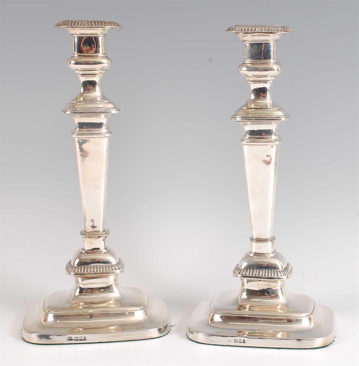 Lot 1213 - A pair of George V silver table candlesticks,...