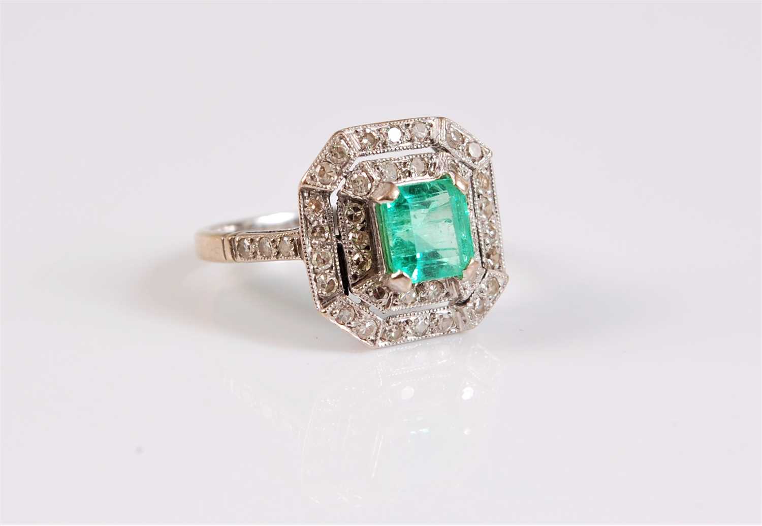 Lot 1259 - An 18ct Art Deco style emerald and diamond...