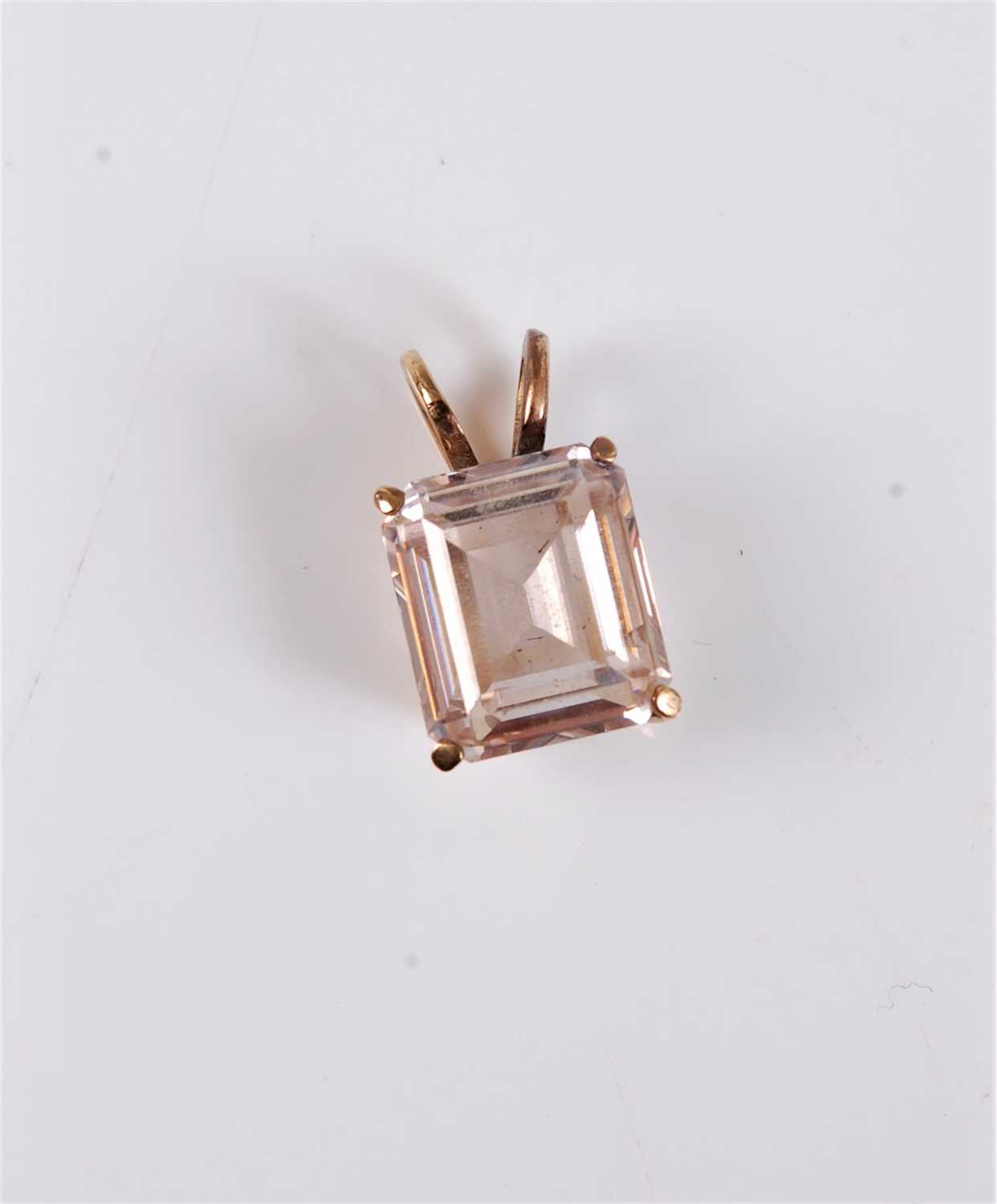 Lot 2583 - A pale pink zircon pendant, the emerald cut...