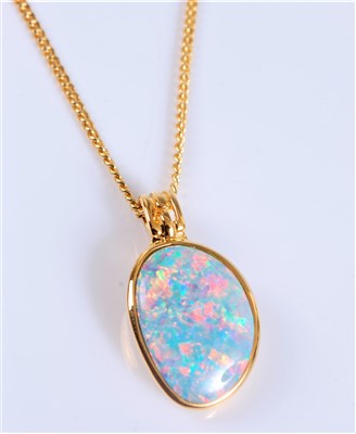 Lot 2636 - A silver gilt opal pendant, the oval opal in...