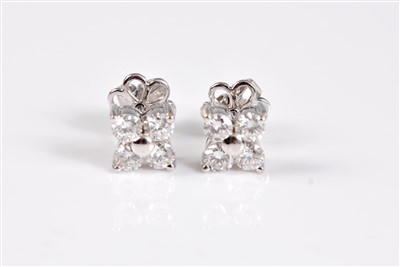 Lot 1249 - A pair of diamond earstuds, each comprised of...