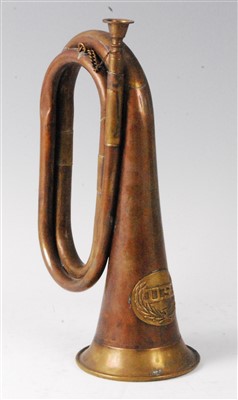 Lot 11 - A brass and copper bugle with applied U.S. crest.