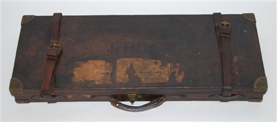 Lot 337 - An early 20th century oak, brown leather and brass bound shotgun case