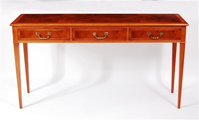 Lot 1597 - A figured walnut three drawer hall table, in...