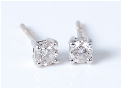 Lot 2569 - A pair of white metal diamond ear studs, the...