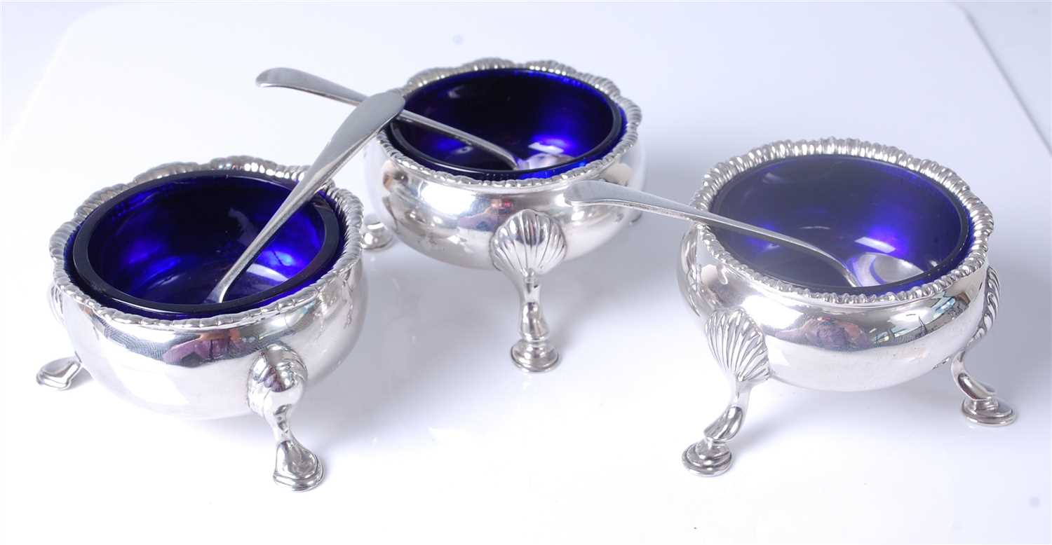 Lot 1157 - A matched set of three George III silver table...