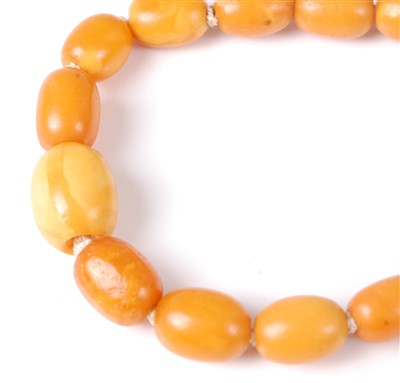 Lot 1275 - A beaded and graduated butterscotch amber...