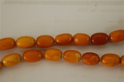 Lot 1275 - A beaded and graduated butterscotch amber...